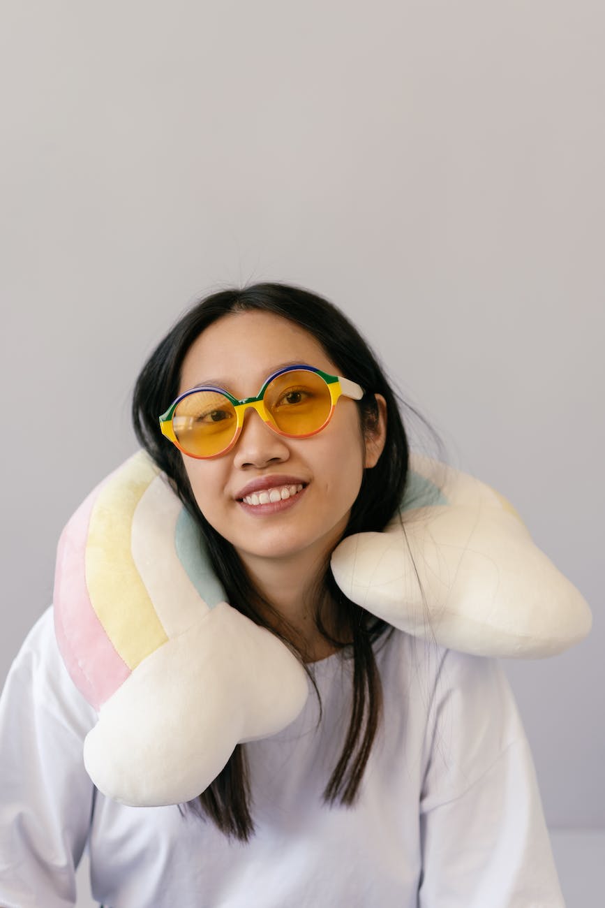 woman wearing glasses with neck pillow